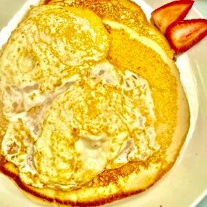 Two Hot Cakes with Two Eggs and your choice of ham, sausage, or bacon