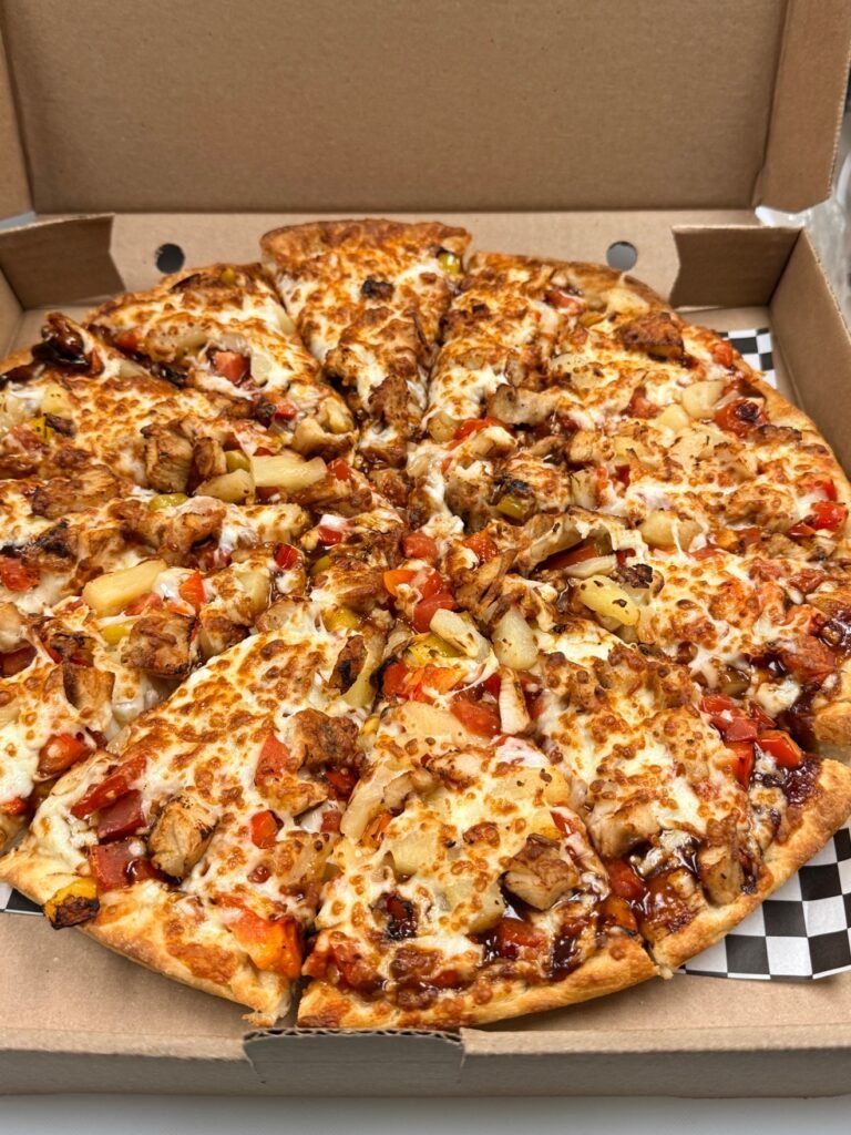 BBQ chicken pizza with pineapple and peppers at Cravings and Delight, a family restaurant near Ellerslie Edmonton