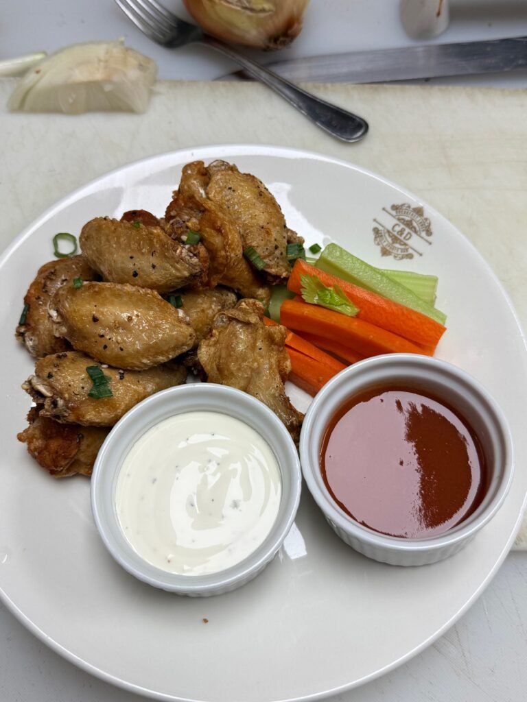 Salt-and-pepper chicken wings with celery, carrots and two dips at Cravings and Delight, a family restaurant near Keswick Edmonton