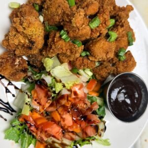 Crispy fried chicken pieces with salad and dip at Cravings and Delight