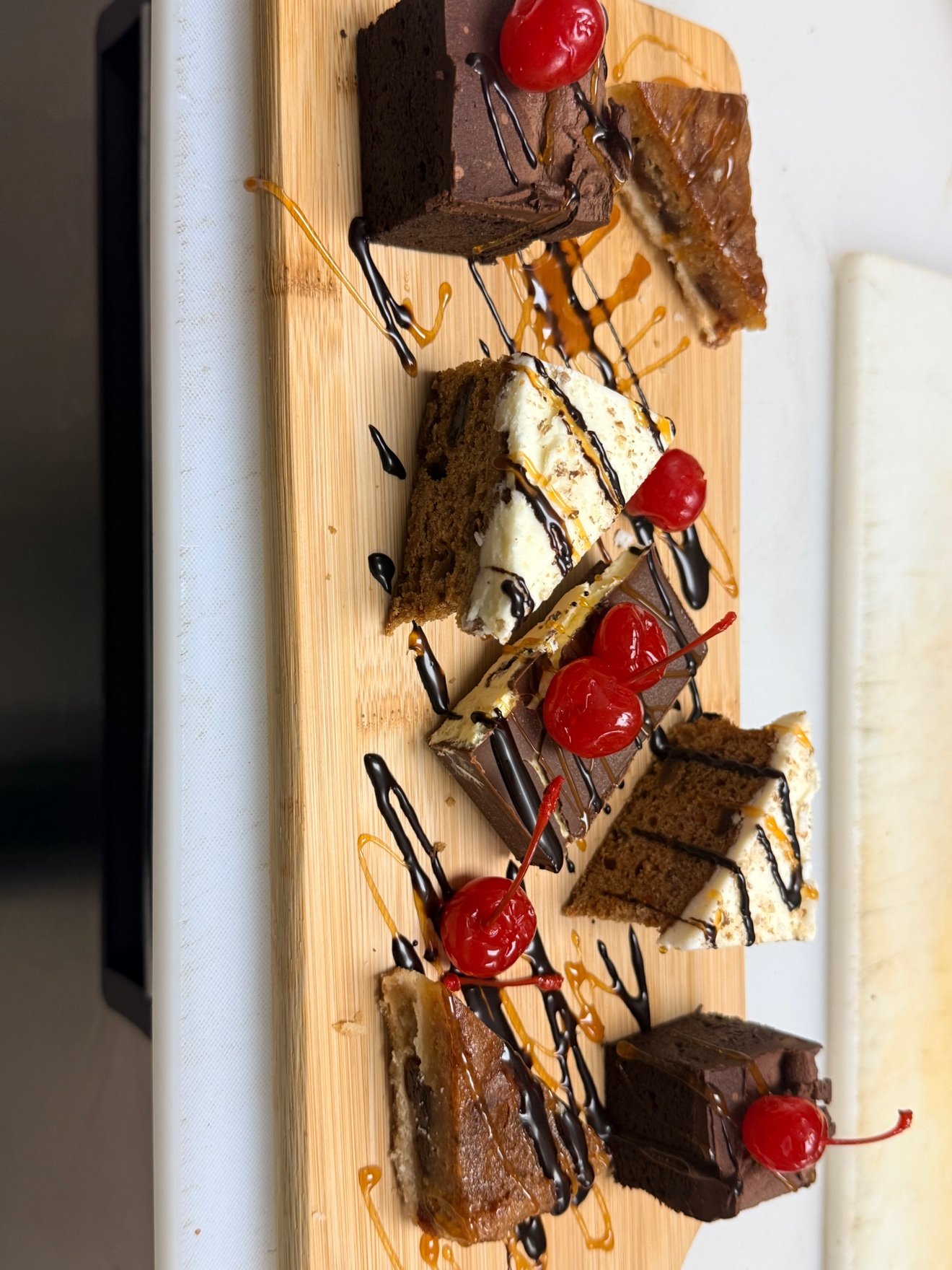 Assorted dessert board with cakes and petit fours at Cravings and Delight