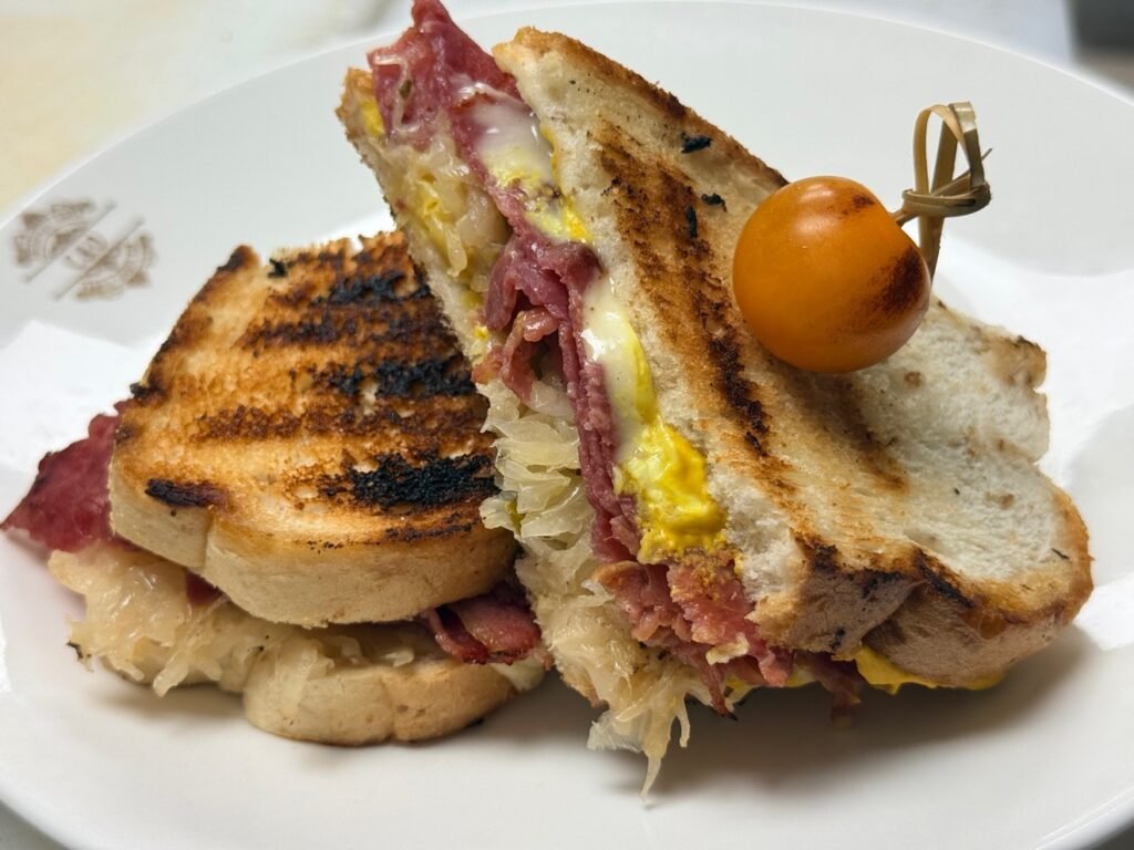 Grilled Reuben sandwich with corned beef, sauerkraut and melted cheese at Cravings and Delight, a family restaurant near Ambleside Edmonton