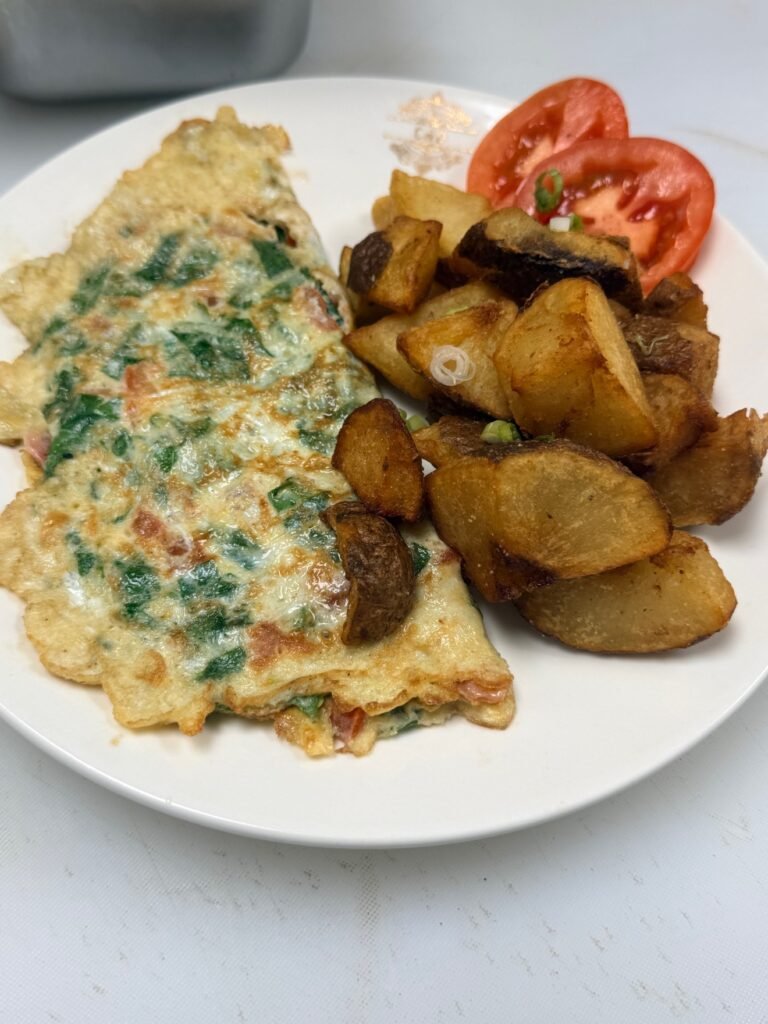 C & D Greek omelette with spinach, home fries and tomato at Cravings and Delight, a breakfast restaurant near Summerside Edmonton